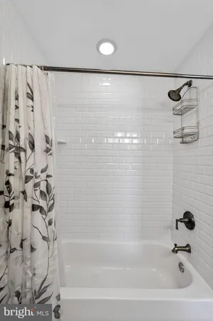 a bathroom with a shower and a bath tub