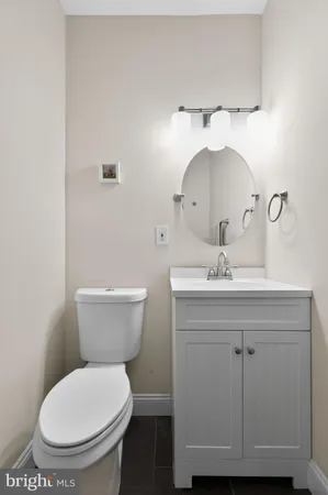 a bathroom with a toilet a sink and mirror