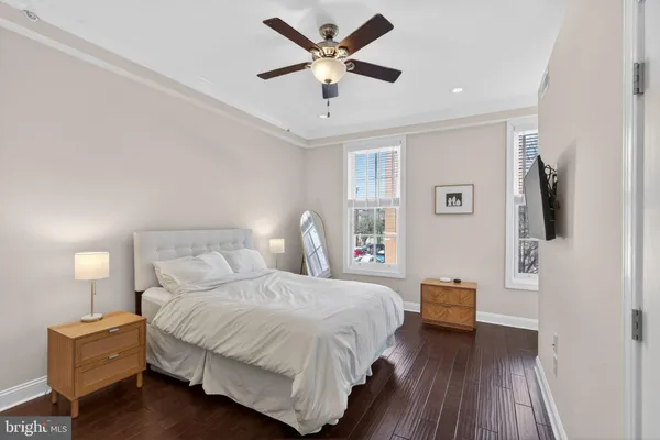 a bedroom with a bed and a potted plant