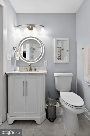 a bathroom with a toilet a sink and a mirror