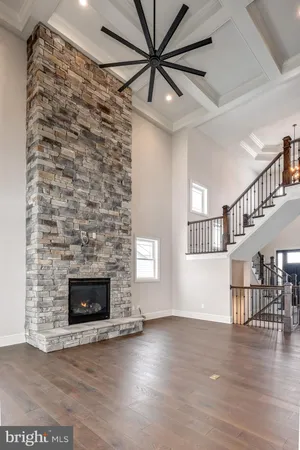 a view of empty room with wooden floor and fireplace