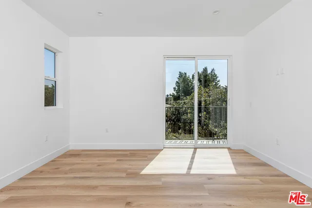 a view of a room with wooden floor and staircase