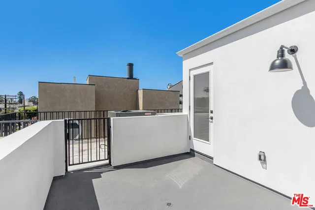 a large white building with a large pool