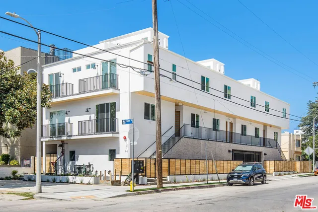 a kitchen with wooden floors and refrigerator