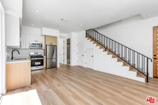 a kitchen with a refrigerator stove and sink