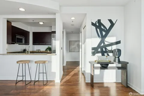 a view of living room and kitchen with furniture wooden floor