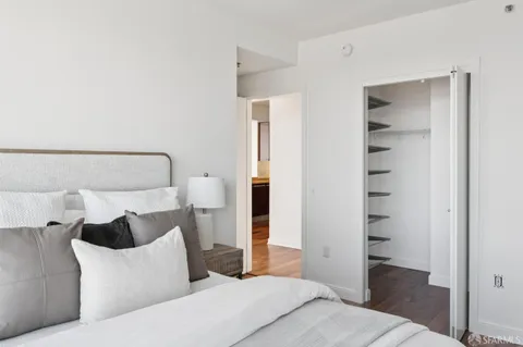 a bedroom with a bed and a walk in closet