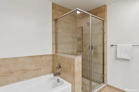 a bathroom with a bathtub and a shower