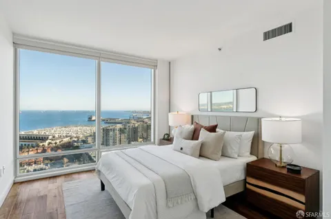 a bedroom with a bed and a night stand