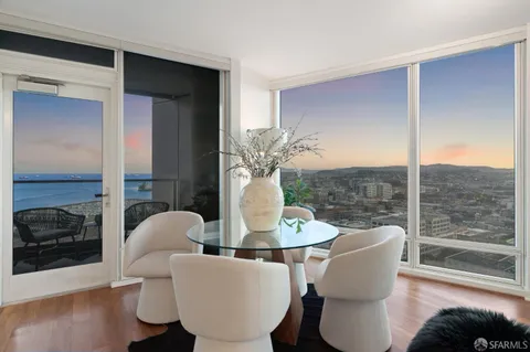 a living room with furniture a lamp and a large window