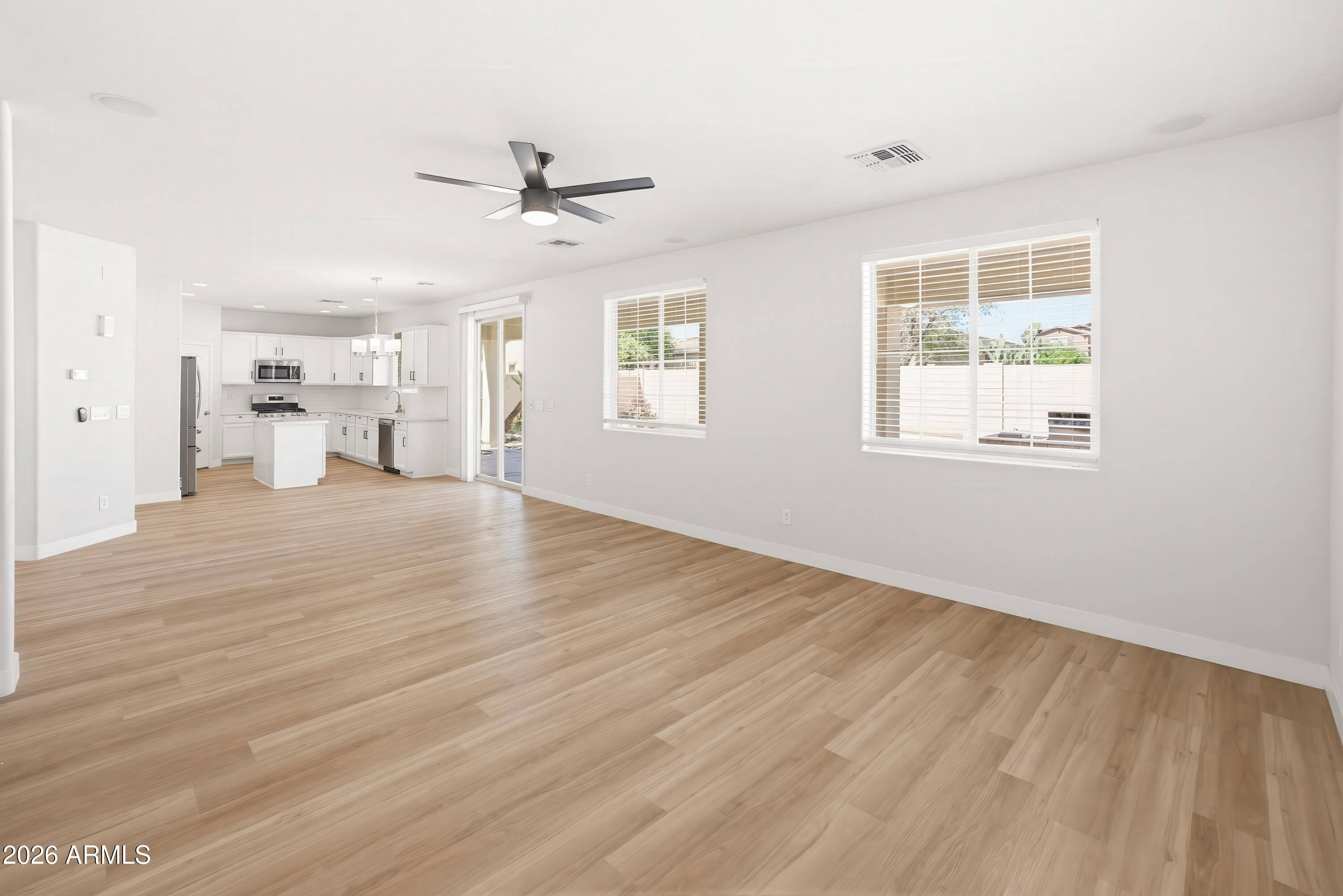 17328 West Bajada Road Surprise, AZ 85387 - Photo 11 of 40 a view of an empty room with wooden floor and a window