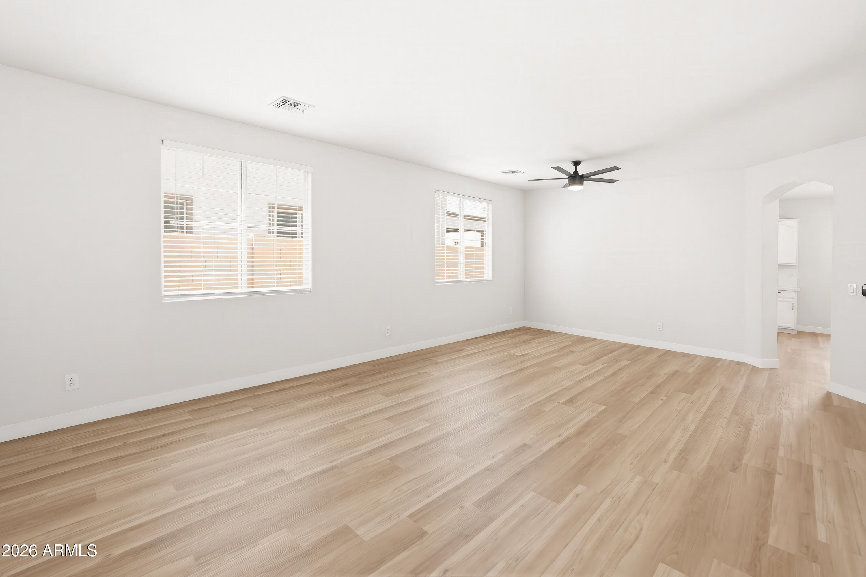 17328 West Bajada Road Surprise, AZ 85387 - Photo 13 of 40 an empty room with wooden floor and windows