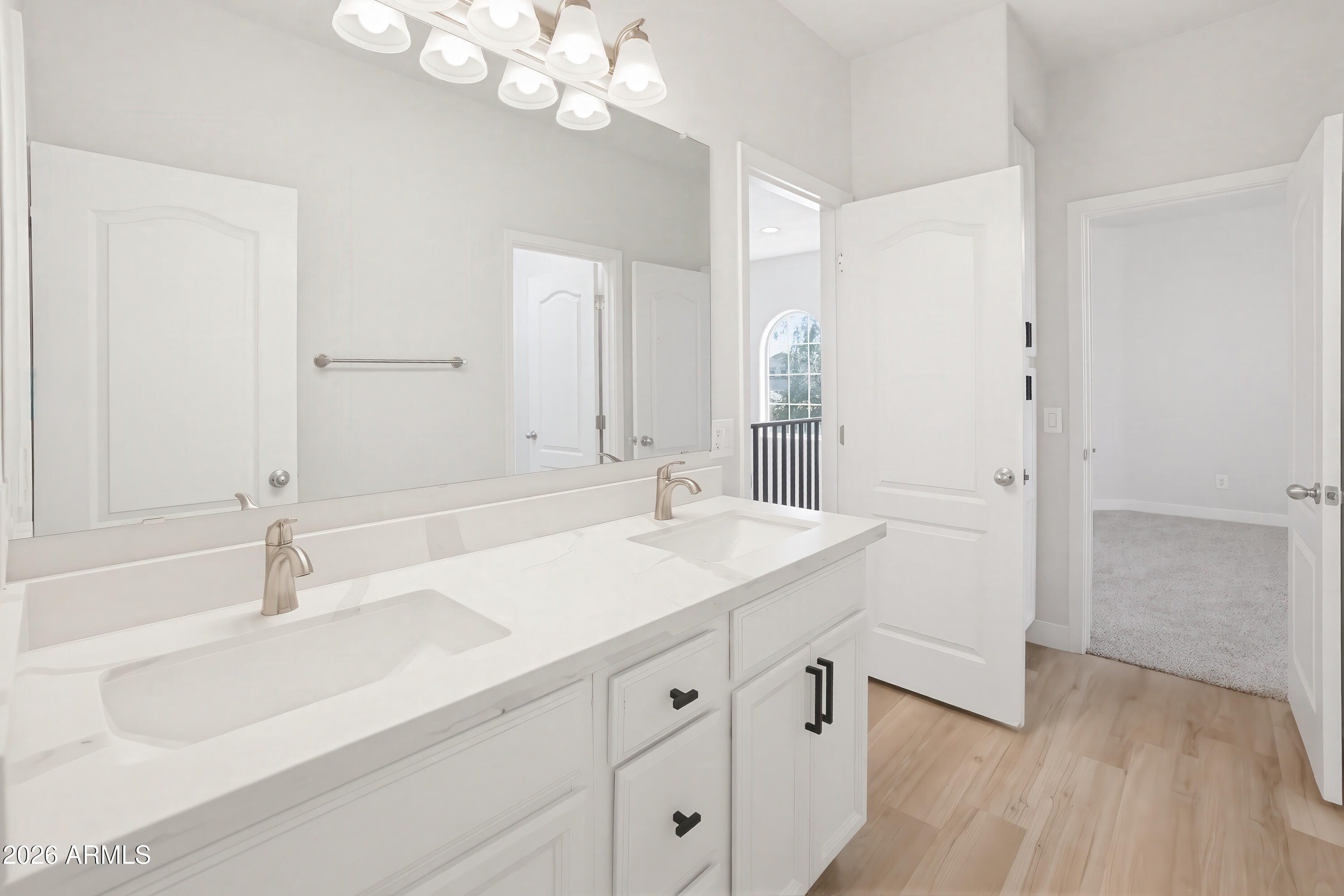 17328 West Bajada Road Surprise, AZ 85387 - Photo 26 of 40 a bathroom with a sink a vanity and a mirror