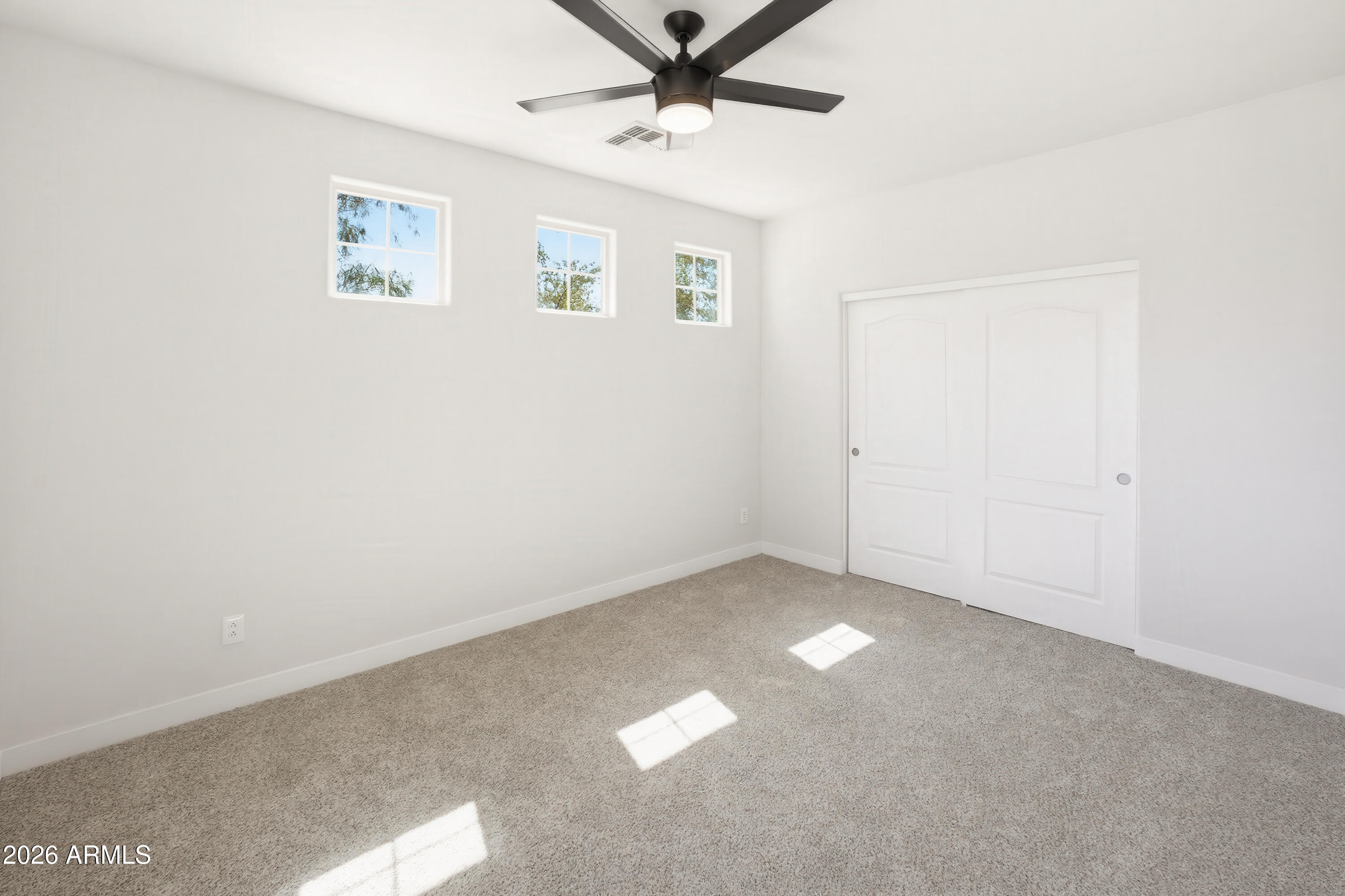 17328 West Bajada Road Surprise, AZ 85387 - Photo 30 of 40 an empty room with windows and fan