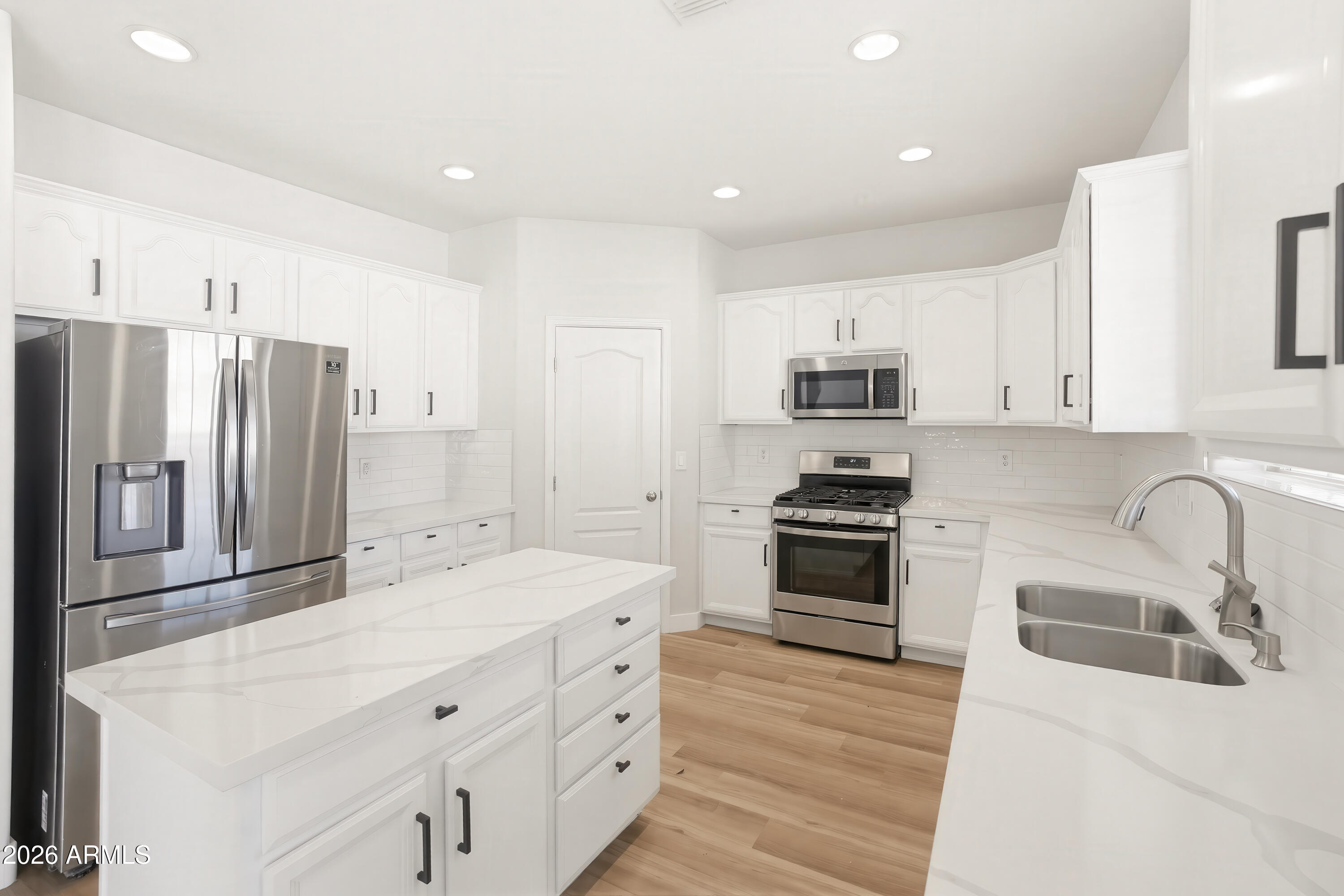 17328 West Bajada Road Surprise, AZ 85387 - Photo 4 of 40 a kitchen with granite countertop a refrigerator stove and sink