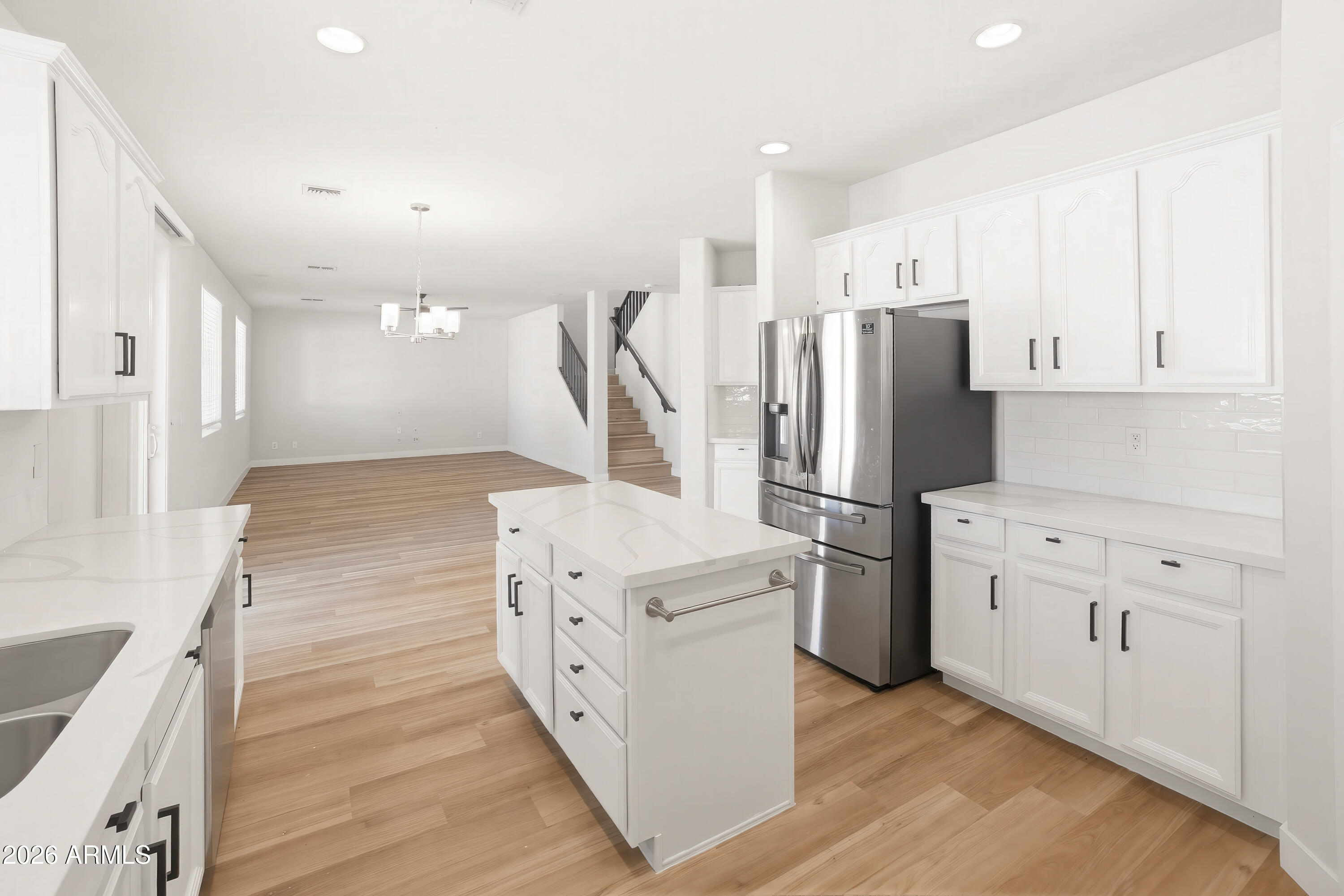 17328 West Bajada Road Surprise, AZ 85387 - Photo 7 of 40 a kitchen with white cabinets and stainless steel appliances