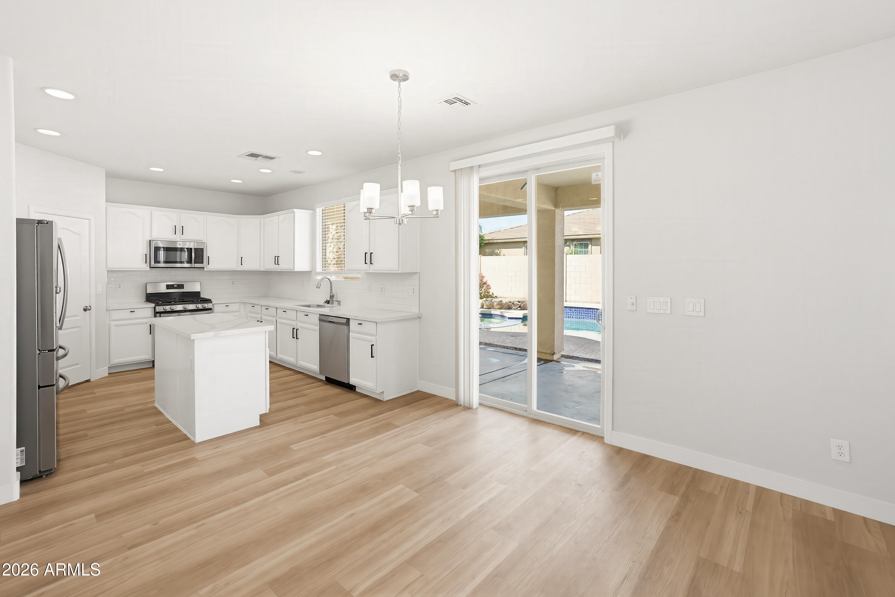 17328 West Bajada Road Surprise, AZ 85387 - Photo 9 of 40 a kitchen with refrigerator and cabinets