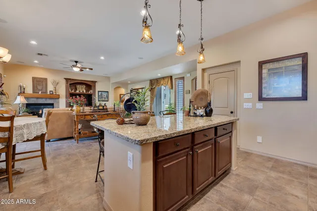 a kitchen with stainless steel appliances granite countertop a sink and a refrigerator