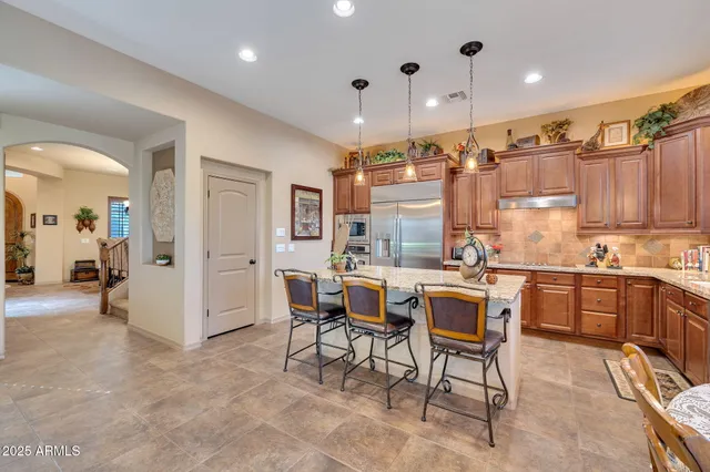 a kitchen with a table and chairs in it