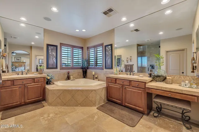 a large bathroom with a large tub and sink