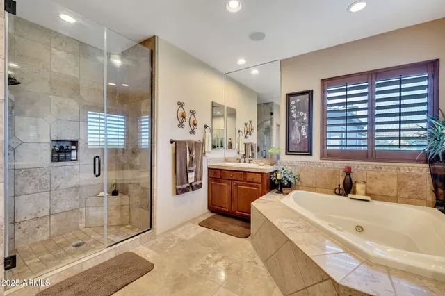 a bathroom with a tub sink and mirror