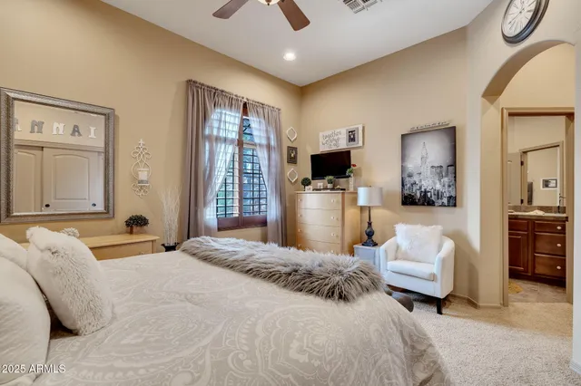 a bedroom with a bed couch and window