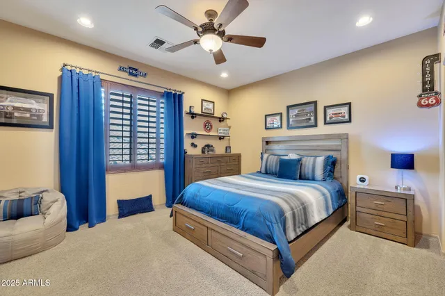 a bedroom with a large bed and a chandelier