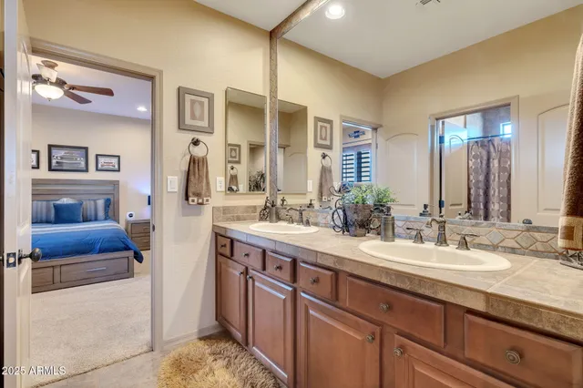 a spacious bathroom with a double vanity sink and a mirror