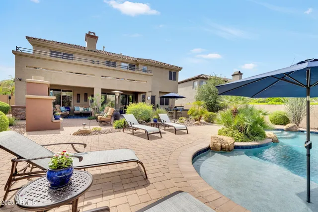 a building outdoor space with patio furniture and potted plants