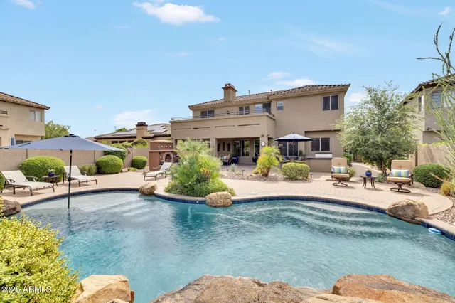 a view of a house with backyard porch and sitting area