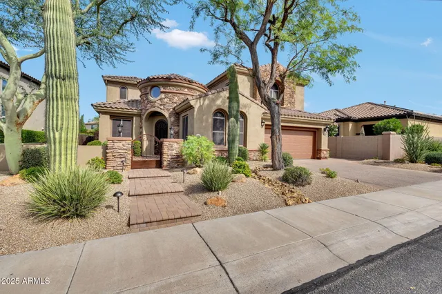 a front view of a house with a garden
