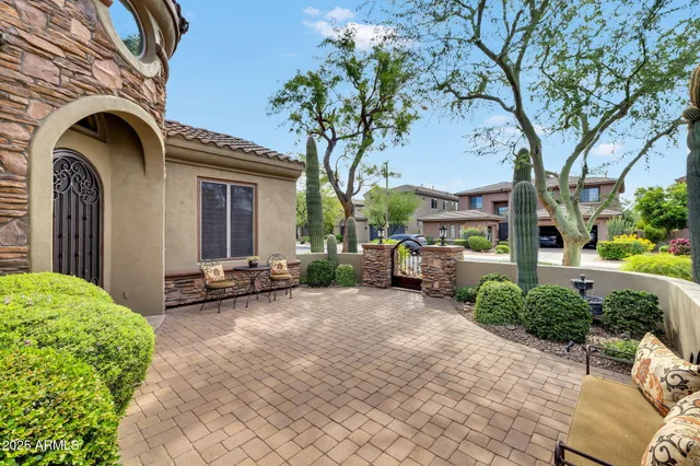 a view of a chair and fire pit in front of a house