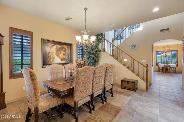 a dining room with furniture entryway and wooden floor