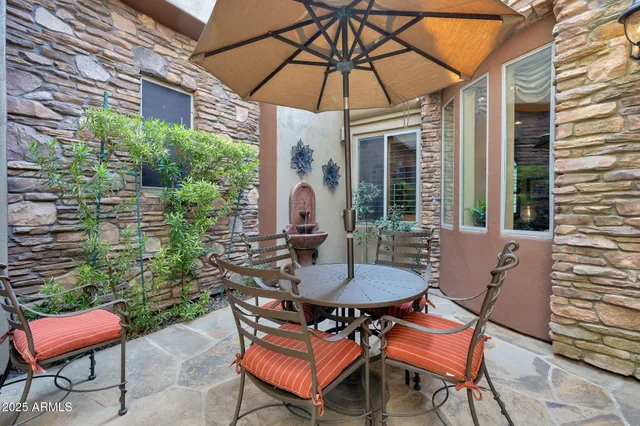 a patio with a table and chairs