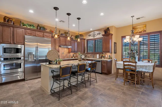 a kitchen with a table chairs stove and cabinets