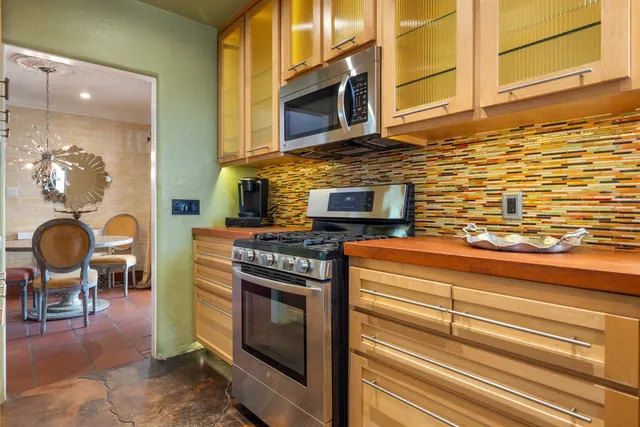 a kitchen with stainless steel appliances granite countertop a stove and a microwave