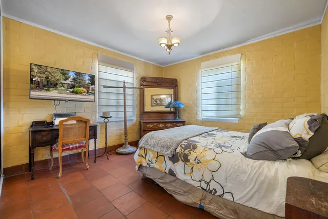 a bedroom with a bed and a chandelier