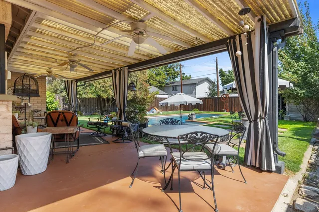 a patio with yard glass top table and chairs