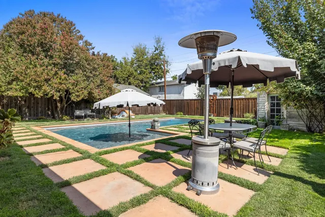 a view of a patio with a table chairs and a backyard