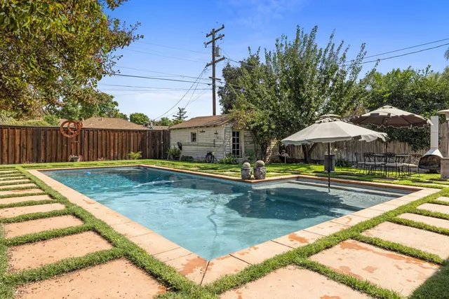 a view of swimming pool with chairs