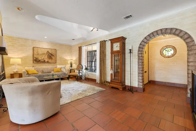 a living room with couches and a large window