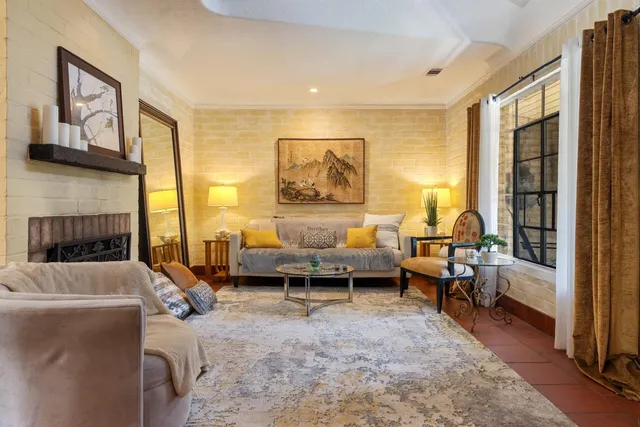 a living room with furniture and a fireplace