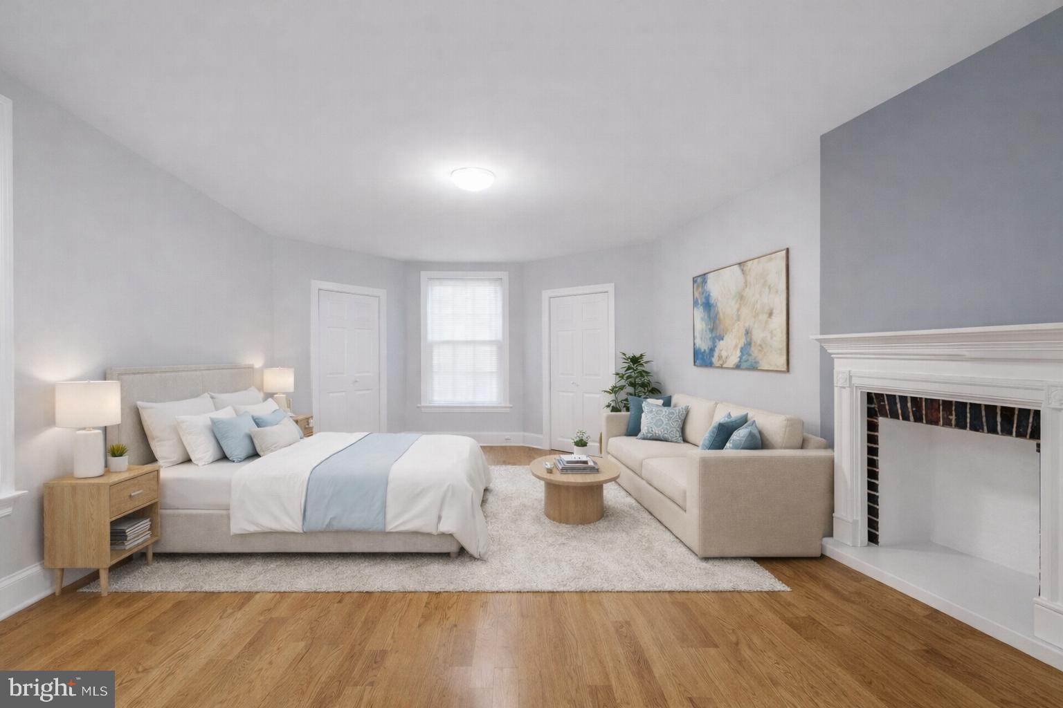 1701-03 Spruce Street, Unit 3R Philadelphia, PA 19103 - Photo 1 of 6 a bedroom with a large bed and a couch