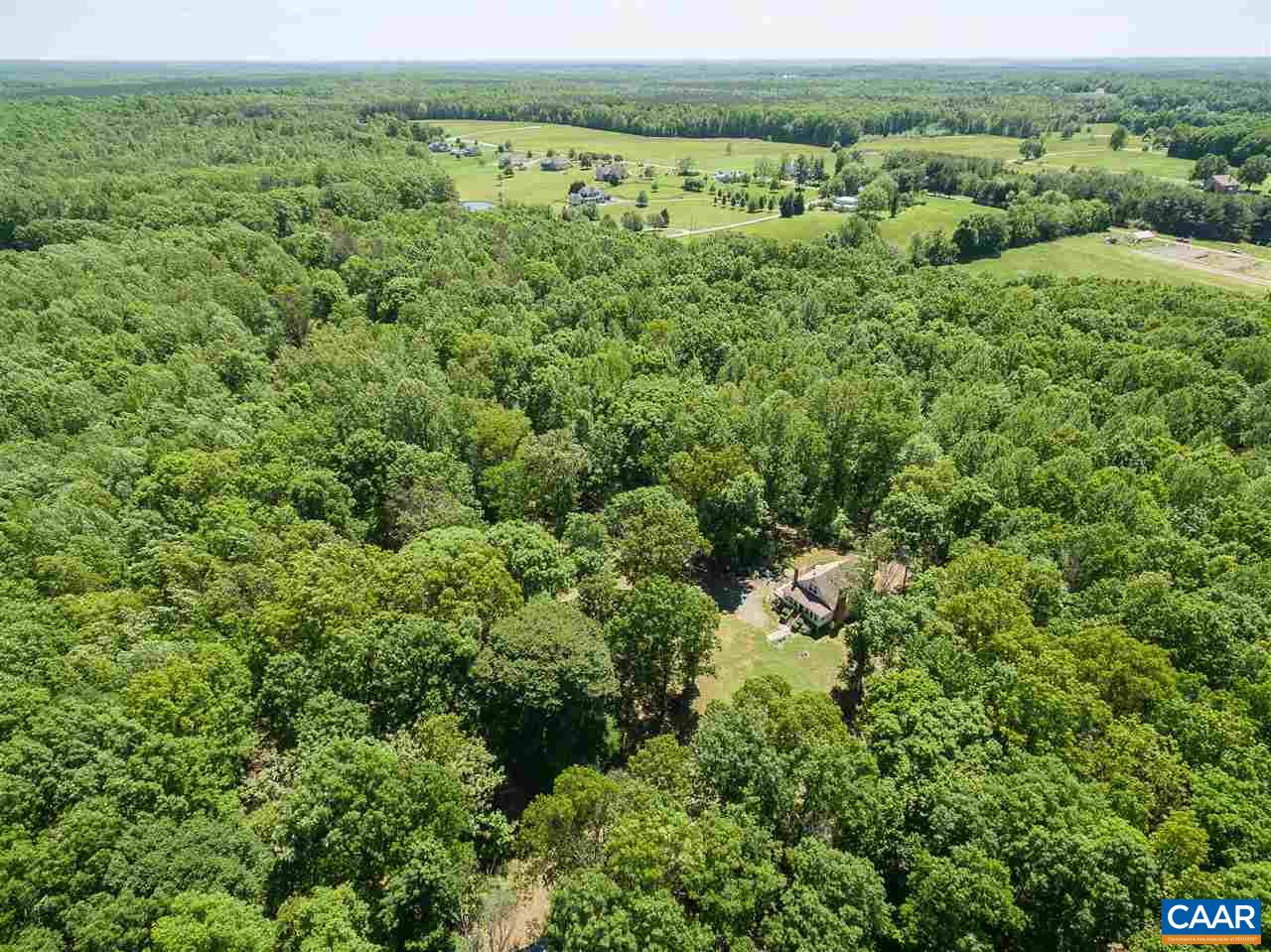 3697 Bybees Church Road Palmyra, VA 22963 - Photo 6 of 11 a view of a lush green forest with trees and some houses
