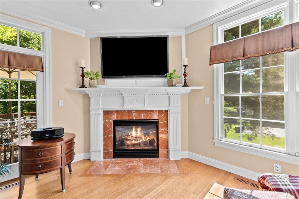 75 Thistle Road North Andover, MA 01845 - Photo 15 of 42 a living room with a fireplace and a flat screen tv