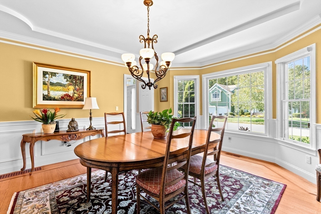 75 Thistle Road North Andover, MA 01845 - Photo 18 of 42 a dining room with furniture a chandelier and wooden floor