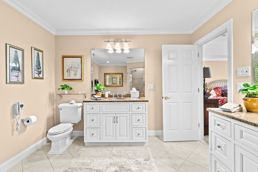 75 Thistle Road North Andover, MA 01845 - Photo 26 of 42 a spacious bathroom with a double vanity sink a mirror a bathtub and a toilet