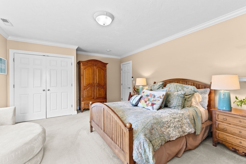 75 Thistle Road North Andover, MA 01845 - Photo 30 of 42 a bedroom with a bed and a lamp