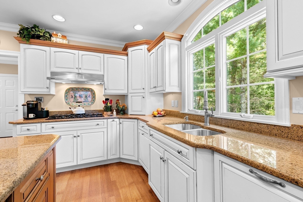 75 Thistle Road North Andover, MA 01845 - Photo 9 of 42 a kitchen with stainless steel appliances granite countertop a sink a stove and cabinets