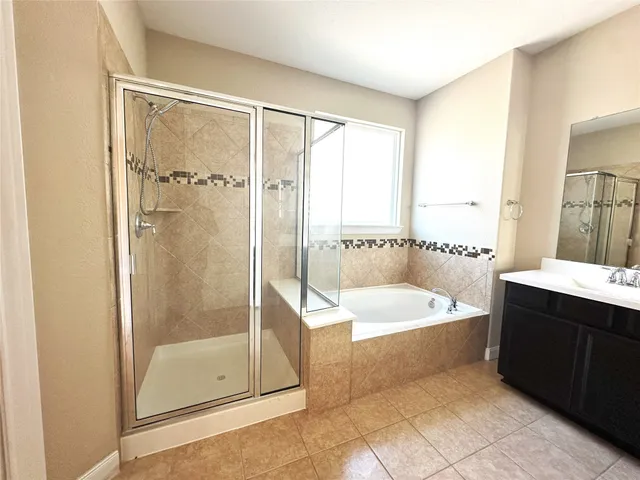 a bath room with a bath tub and a shower